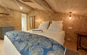 A bedroom with a bed, a dresser, a mirror, and a nightstand. - Nice home in Les Gonds with private swimming pool, can be inside or outside (Les Gonds)