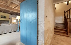 A room with a blue door, a staircase, a sofa, and a lamp. - Nice home in Les Gonds with private swimming pool, can be inside or outside (Les Gonds)