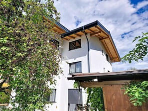 A modern two-story building with a white facade, large windows, and a wooden roof structure. - "das maridl" by Interhome (Ried im Oberinntal)