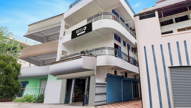 A multi-story hotel with a prominent 'HOTEL' sign on the second floor, featuring balconies with metal railings. - Super Hotel Junction Formerly Bhagwan (Dehradun)