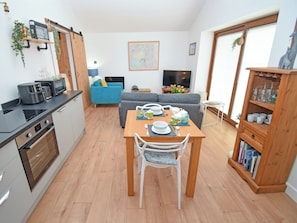 A modern living space with a kitchen, dining area, and seating area. - 1 bedroom accommodation in Carr Bank, Arnside (Carr Bank, Arnside)