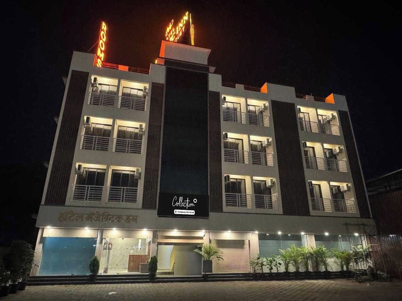 A multi-story hotel with a prominent 'Rooms' sign, a 'Collection' sign, and a visible entrance with a covered area.