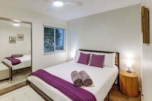 A bedroom with a bed, a bedside lamp, a window with blinds, a mirror, and a wall-mounted picture. - Outdoor Oasis w/ Private Hot Tub! San Diego Gem (San Diego)