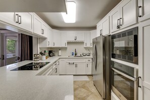 A modern kitchen with white cabinetry, stainless steel appliances, and a central island. - Outdoor Oasis w/ Private Hot Tub! San Diego Gem (San Diego)