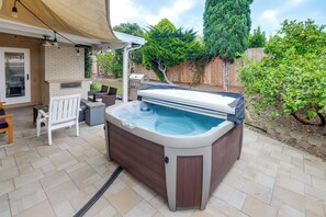 A backyard with a hot tub, outdoor grill, and seating area. - Outdoor Oasis w/ Private Hot Tub! San Diego Gem (San Diego)