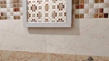 A bathroom with a sink, mirror, and tiled backsplash.