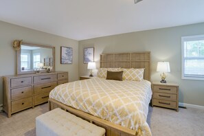 A bedroom with a bed, nightstands, a dresser, a mirror, and two wall-mounted lamps. - Walk to Lake & Downtown! 6 Mi to Boyne Mtn (Boyne City)