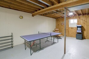 A ping pong table in a room with wooden walls and a ceiling with exposed beams. - Walk to Lake & Downtown! 6 Mi to Boyne Mtn (Boyne City)