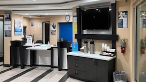 A reception area with a counter, chairs, a clock, and informational posters on the walls. - 2 Queen Beds | Non-Smoking, Kitchen (Vallejo)