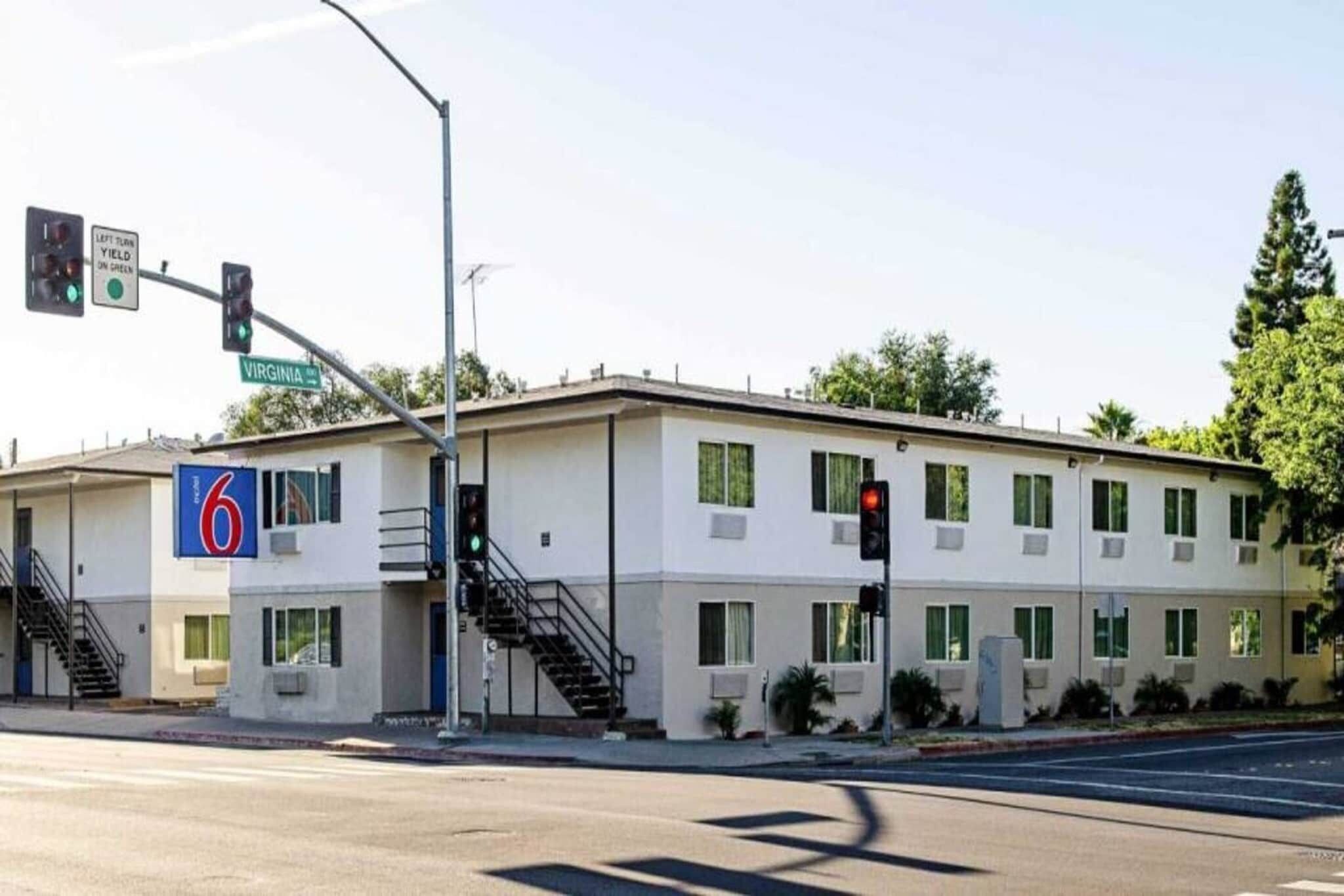 A two-story motel with a sign indicating it is number 6.