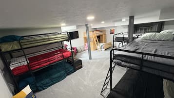 Un dormitorio con literas, un escritorio y una silla.