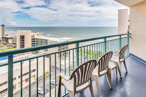 A balcony with chairs overlooking a beach and cityscape. - Sand Dunes Resort Condo w/ Water Views! (Myrtle Beach)