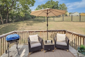 An outdoor patio with wicker furniture, a barbecue grill, and a canopy umbrella. - Hands of Pearls Easy Access to 12 South Nashville (Nashville)