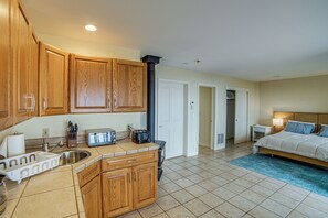 A compact kitchen with wooden cabinets, a toaster, and a sink.