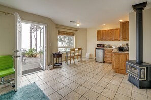 A spacious kitchen with a large stove, wooden cabinets, and a dining area with a table and chairs.