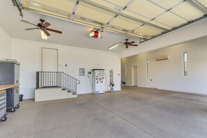 A spacious room with a high ceiling, two ceiling fans, a refrigerator, and a door leading to another room. - Mtn Views, Hot Tub! Extended Lake Havasu Escape (Lake Havasu City)