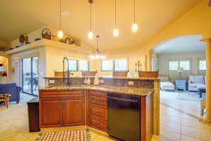 A spacious kitchen with a large island, overhead pendant lights, and a view to the living area. - Private Yard w/ Fire Pit & Pool! Cape Coral Escape (Cape Coral)
