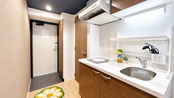 A modern kitchen with a sink, cabinets, and a countertop.