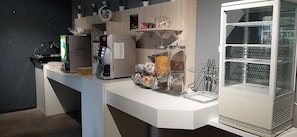 A modern kitchen with a coffee machine, a refrigerator, and a glass display case. - Appart'hôtel Martinez (Grenay)