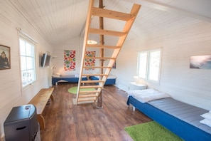 A room with a wooden ladder, a bench, a bed, and a small table. - Holiday home with 3 bedrooms (Loftahammar)