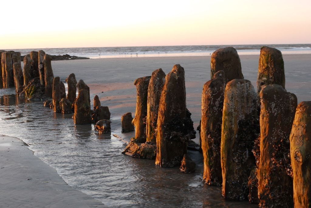 A beach with tall, vertical rock formations.