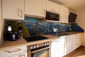 A kitchen with a microwave, stove, and coffee maker. - Holiday apartment with 2 bedrooms (Neustift im Stuibaital)