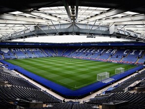 A stadium with multiple tiers of seating, a central field, and a roof structure. - Sav Regent Leicester-Studio Walking to City Centre (Leicester)