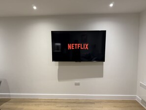 A room with a mounted television on the wall, a light switch, and a power outlet. - 2 Bed+Sofa in Sale Near Airport & Trafford Centre (Wythenshawe)