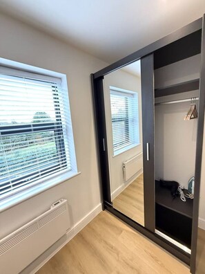 A room with a sliding door closet, a radiator, and a window with blinds. - 2 Bed+Sofa in Sale Near Airport & Trafford Centre (Wythenshawe)