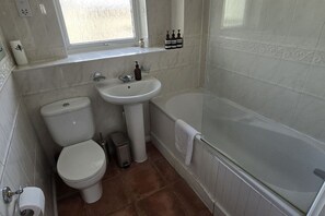 A bathroom with a toilet, sink, and bathtub. - SAV 2-Bed Flat, Uxbridge (Greater London)
