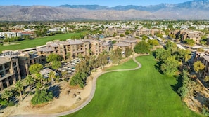 An aerial view of a resort with multiple buildings, a golf course, and mountainous terrain in the background. - Palm Desert Resort Stay with Pools, Golf & Spacious 1BR Villa Escape (Palm Desert)