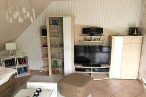 A compact living space with a television, storage cabinets, and a seating area. - in an idyllic location in Klink (Klink)