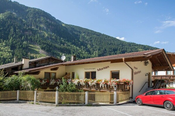 A traditional building with a sign reading 'Marian' and 'Feriendienstleistungen,' indicating it may offer lodging and services.