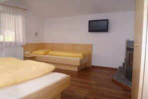 A bedroom with a bed, a television, and a fireplace. - Holiday home in Neustift with barbecue (Neustift)