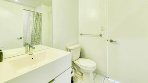 A modern bathroom with a white sink, a toilet, and a shower area. - StayToronto - Terrace 21 Apartments (Toronto)