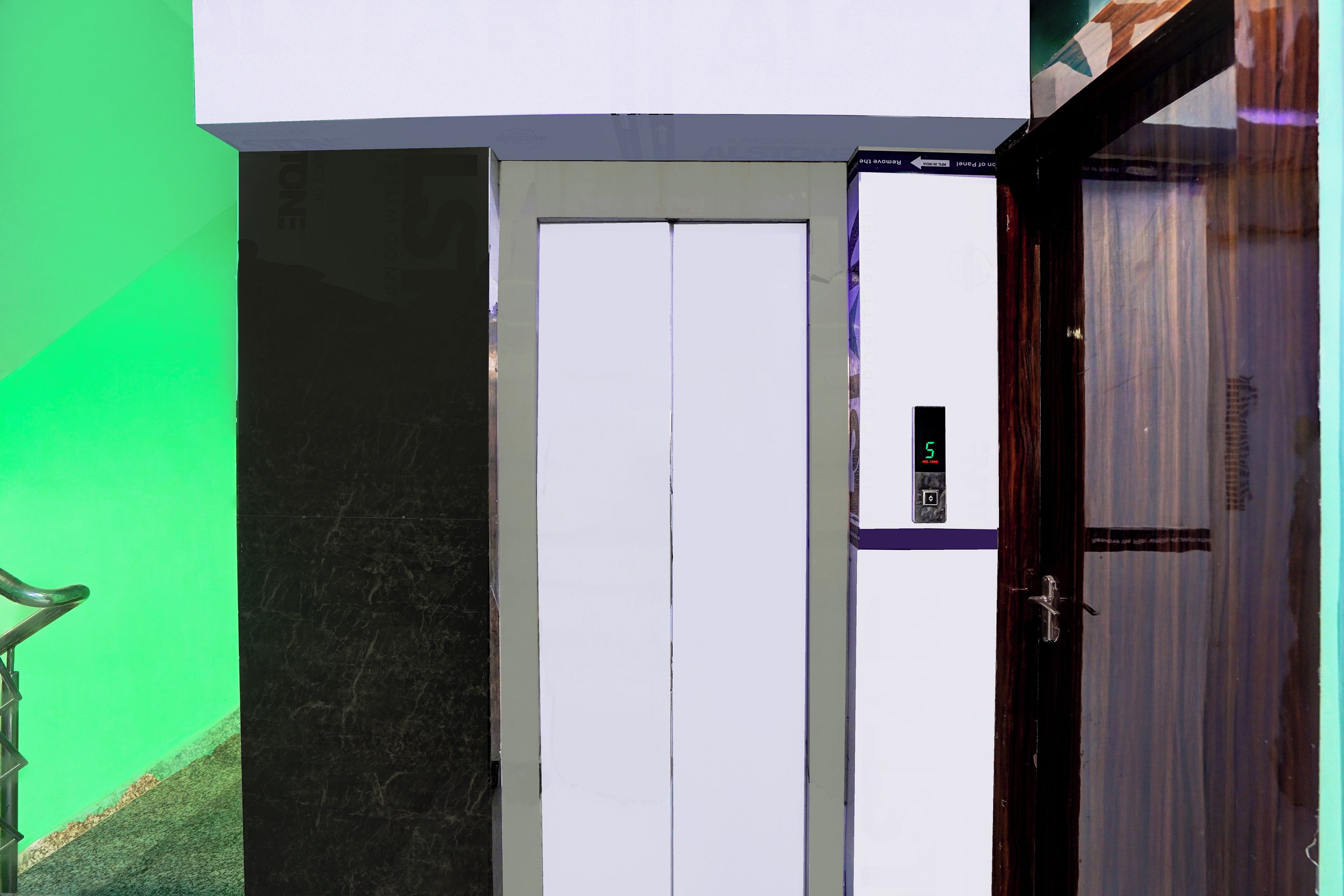 A door with a digital display, a green wall, and a marble floor.