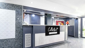 A reception desk with a sign that reads 'Collection Company-Serviced'. - Collection O Railway Station (Raipur)