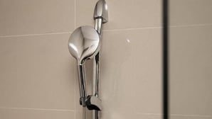 A shower with a chrome faucet and handheld showerhead. - City Comfort Inn Xingtai Wanda (Xingtai)