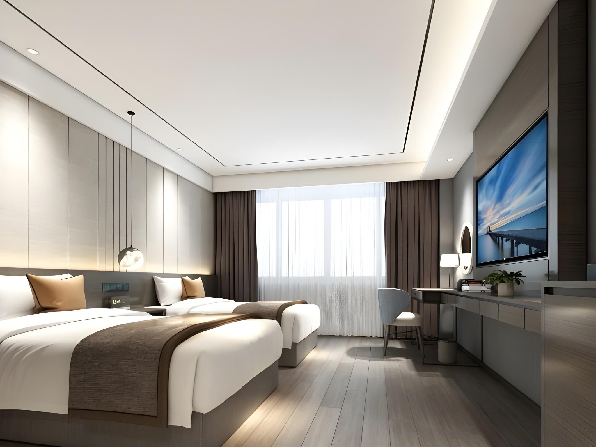Quarto de hotel moderno com uma cama grande, uma escrivaninha e uma televisão.