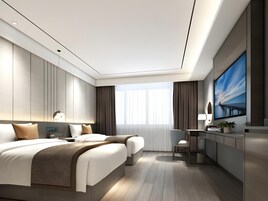 A modern hotel room with a large bed, a desk, and a TV.