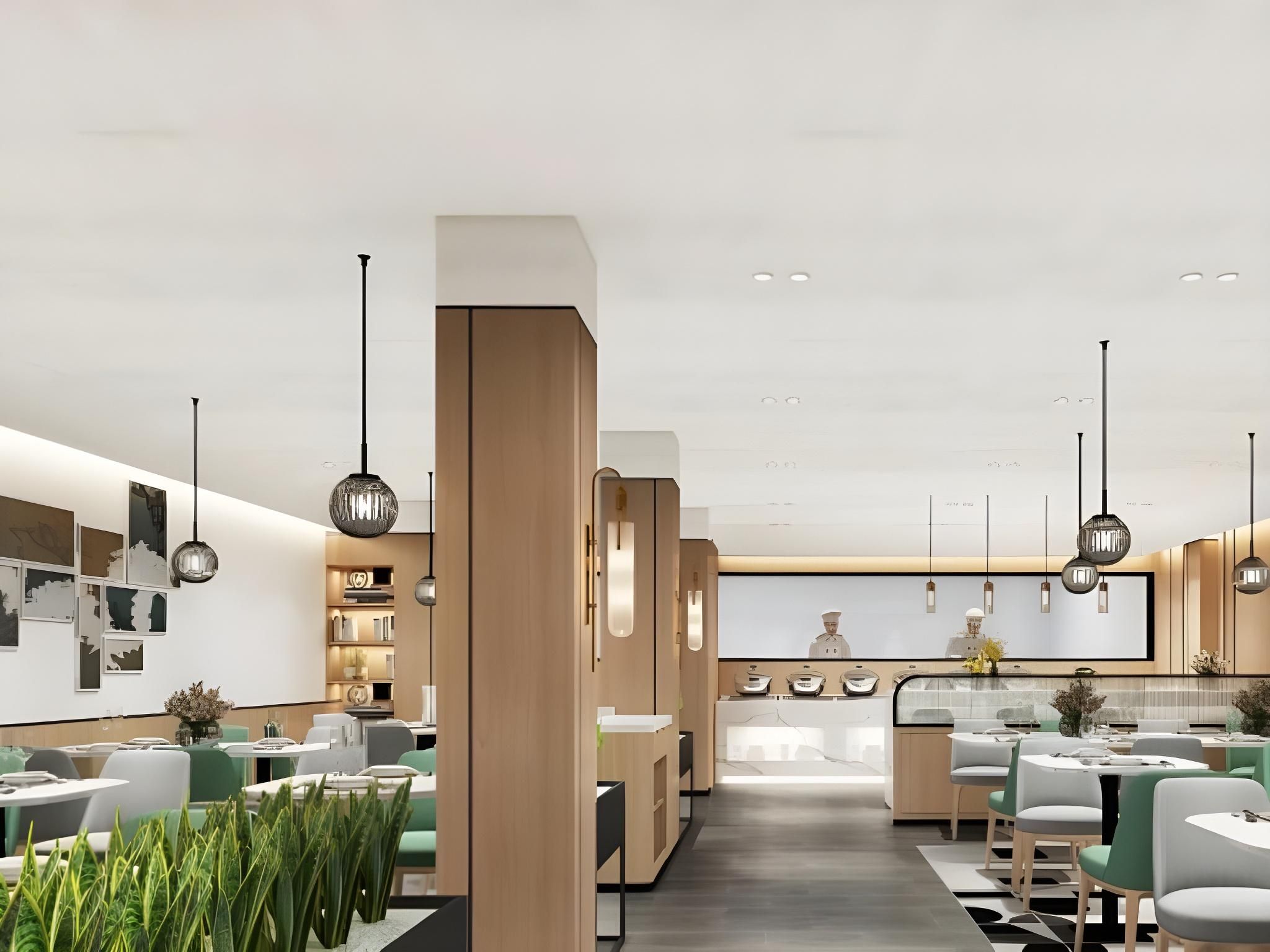 Um restaurante moderno com balcão central, várias mesas de jantar e iluminação pendente.