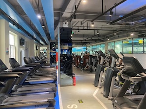 A gym with treadmills, weight machines, and exercise equipment. - Lavande Hotel (Beijing)