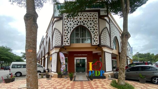 A hotel with a checkered pavement entrance, a large arched window, and a sign reading 'HOTEL DESARU PENAMAR'. - Hotel Desaru Penawar (Bandar Penawar)