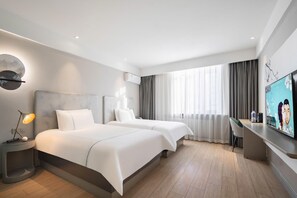 A modern hotel room with two beds, a desk, a flat-screen TV, and a large window with curtains. - Magnotel (Harbin)
