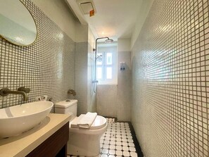 A bathroom with a white sink, toilet, and shower. - White Mansion Hotel (George Town)