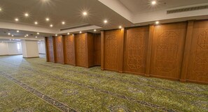 A hotel corridor with patterned carpet, wooden paneling, and recessed lighting. - Grand Al Massa Hotel (Makkah)