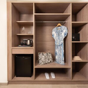 A wardrobe with multiple compartments, including a hanging space for a dress and a shelf with a kettle and glasses. - Ixia Dream - Adults Only (Rhodes)