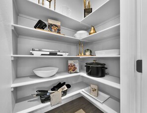 A kitchen pantry with shelves, a cookbook, a pot, and kitchen utensils. - Sleeps 16 | Hot Tub +Game Garage + Kids' Play Loft (Meridian)