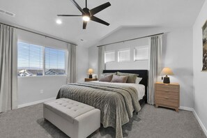 A bedroom with a bed, bedside tables, a ceiling fan, and a window with blinds. - Sleeps 16 | Hot Tub +Game Garage + Kids' Play Loft (Meridian)
