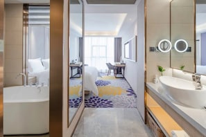 A modern hotel bathroom with a large bathtub, a double sink, and a mirror with a light. - Lavande Hotel (Chengdu)